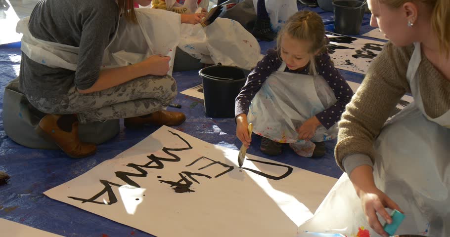 woman mum or educator wipes the paper sheet with a sponge kids are writing - Painting Sheet For Kids woman mum or educator wipes the paper sheet with a sponge kids are writing - Painting Sheet For Kids