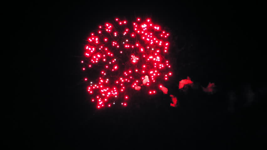 Colorful fireworks in the night sky. Red, blue and green flashes. Clouds of smoke. (av13272c)