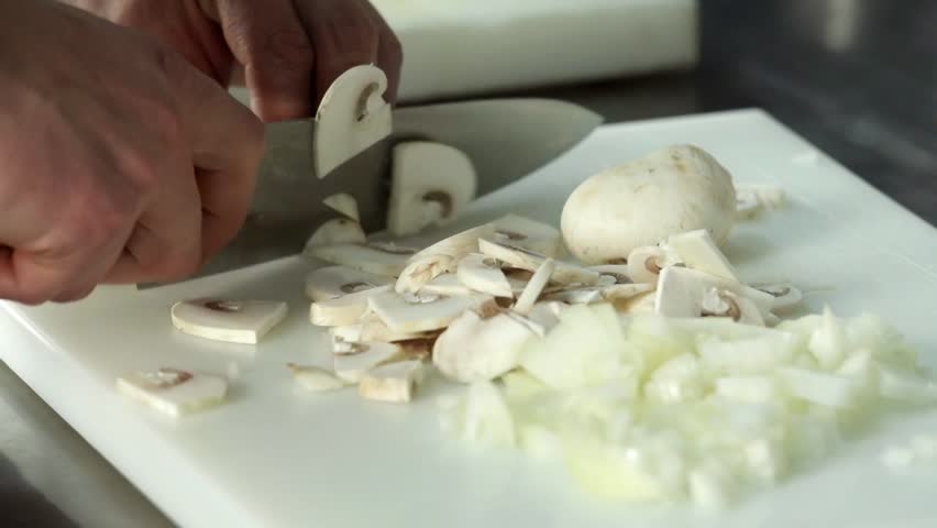 Restaurant Kitchen Video chef hand cutting with knife onion 4k close up video. chopped food Restaurant Kitchen Video chef hand cutting with knife onion 4k close up video. chopped food