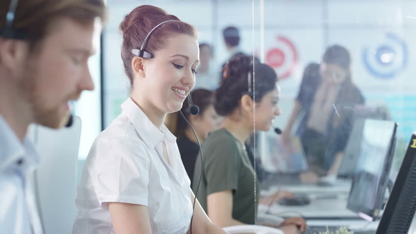 4K Portrait Smiling Customer Service Operator Taking Calls In Busy Call ...