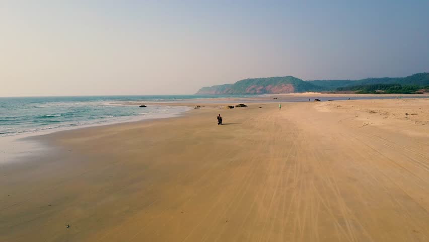 The beast holidays ever. Honeymoon of a great couple. Riding a motorbike through the Paradise Beach, Maharashtra, India. It's only 20 minutes from the last beach of north Goa - Querim.