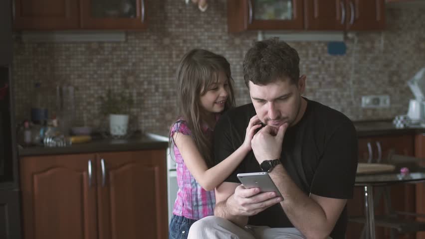 Happy Couple At Home In Kitchen At Breakfast Using Smartphone Together ...