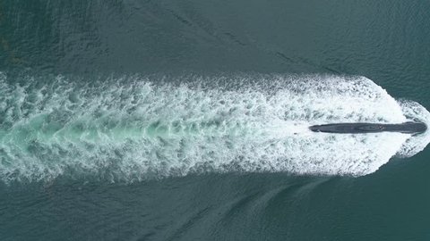 Submarine sailing on the surface shot from straight above, a unique viewpoint of such a vessel