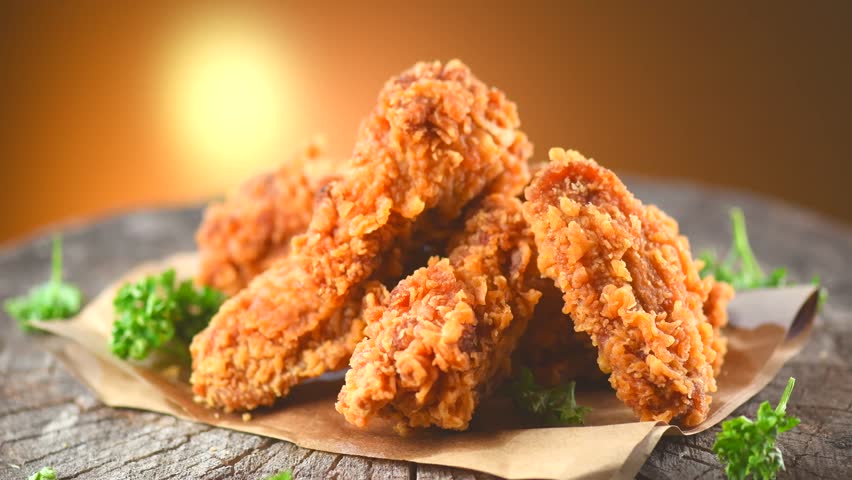 Crispy Fried Chicken Wings And Legs On A Wooden Table Rotation 360 ...