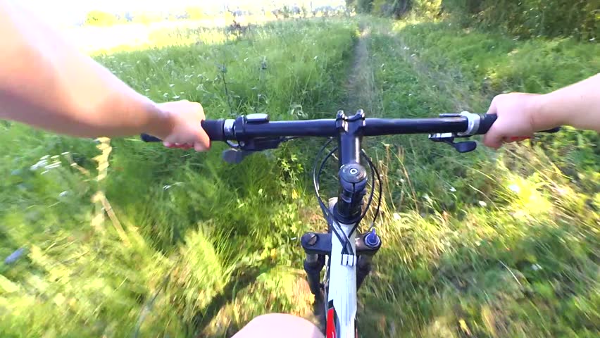 Extreme Girl Rides A Bicycle Along The River Bank Point Of View Pov