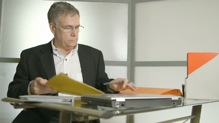A Handsome Man In His Office Sitting At Desk Working A Fatigued Man Working At His Desk Removes Gl And Shows Symptoms Of Headache