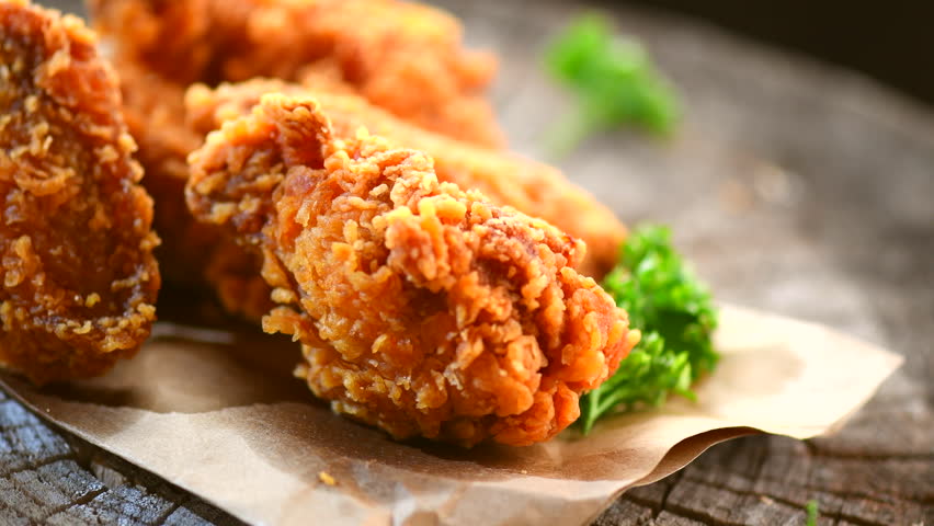 Crispy Fried Chicken Wings And Legs On A Wooden Table Rotation 360 ...