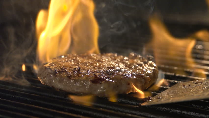 Aged prime rare roast grilling tenderloin fresh juicy beef filet with lines slow motion. Closeup blur macro concept of person cooked unhealthy satisfying hamburgers outdoors for friends picnic party