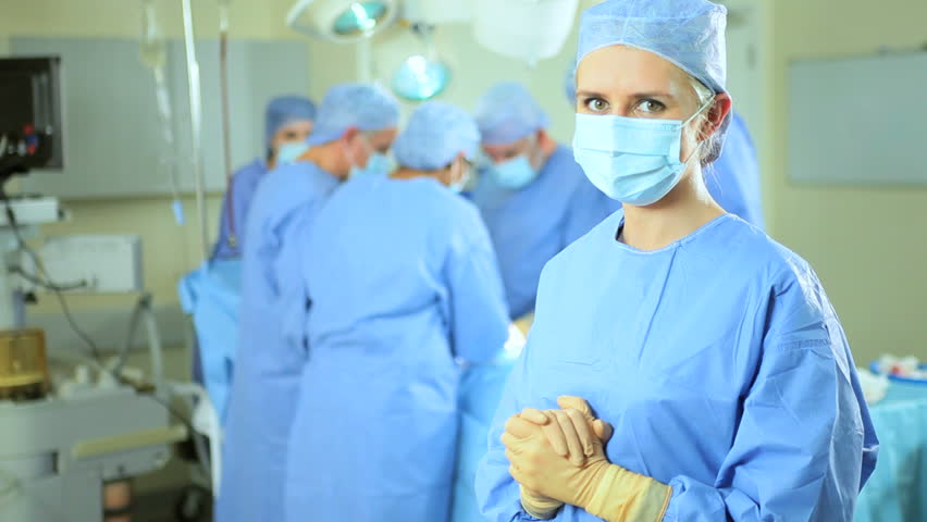 Experienced Surgical Team Performing Operation Behind Female Theater ...