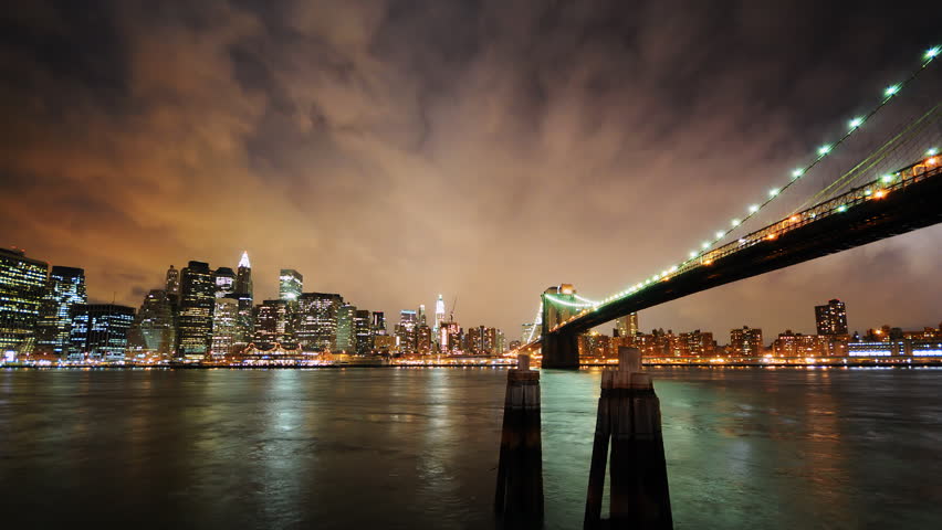 New York City Night Skyline With Brooklyn Bridge Reflected In Water ...