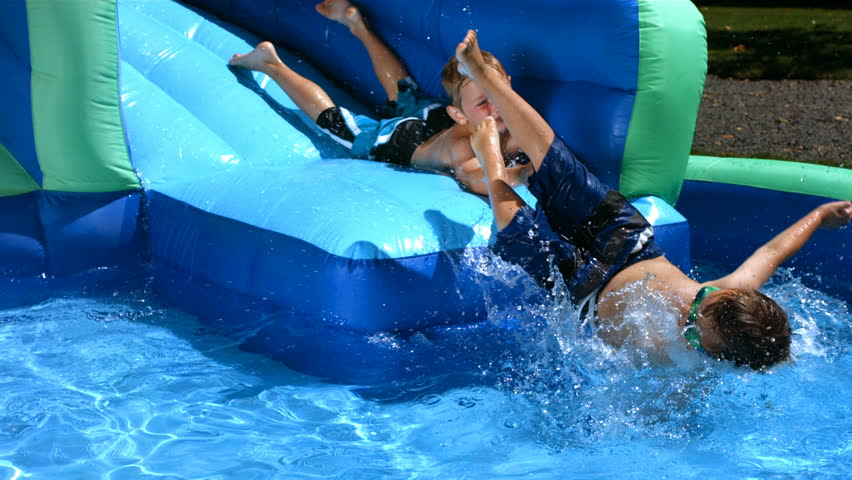 Young Boy Playing In A Swimming Pool On A Float Tube Stock Footage ...