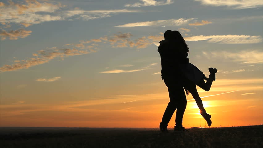 Romantic Young Couple Silhouette. The Guy Holding The Hands Of The Girl ...