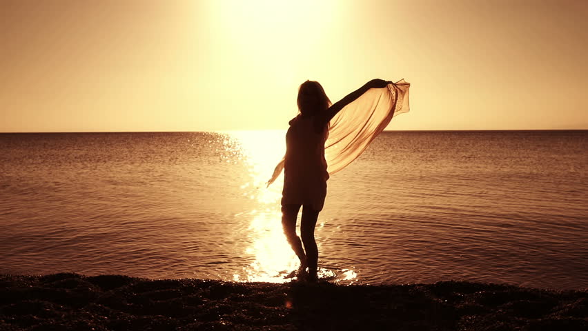 Woman Standing Near Rock And Looking To The Horizon Over Sea Stock ...