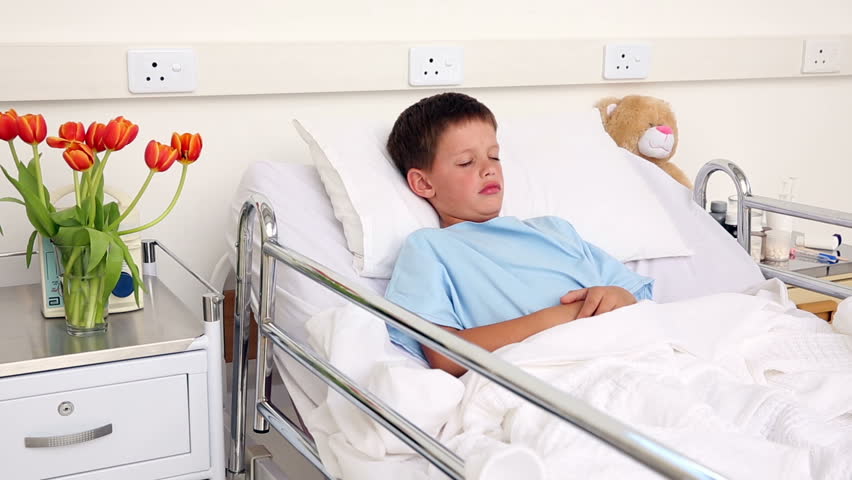 Doctor Checking The Ears Of Little Sick Boy Sitting In Bed In The ...