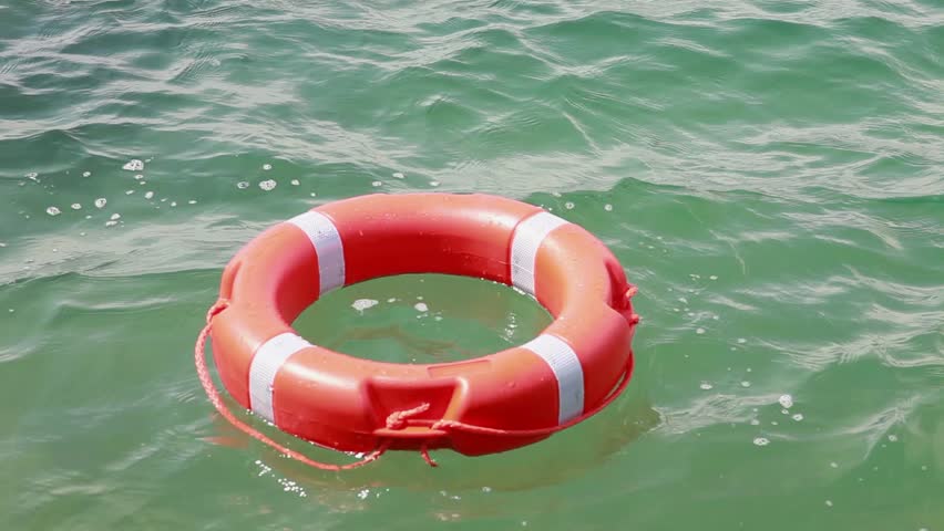 Close Up Shot Of A Red Rescue Buoy Floating On The Water Surface/A ...