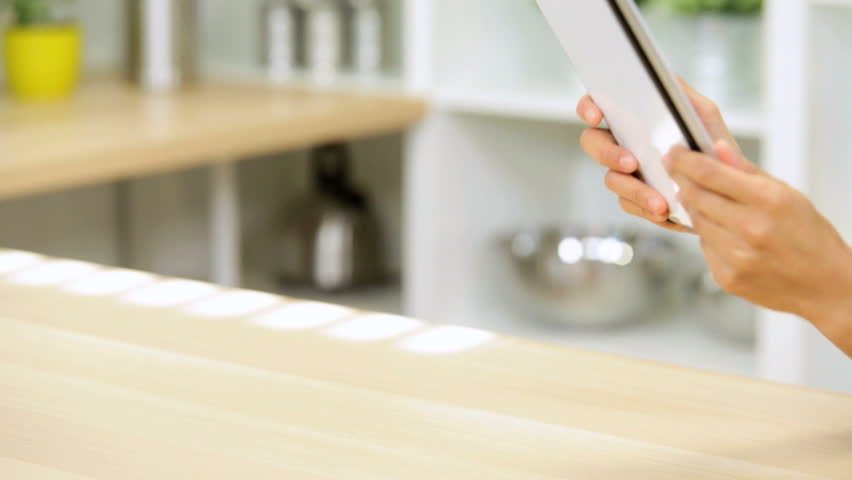 Kitchen Counter Close Up ethnic female eating fruit listening music kitchen close up Kitchen Counter Close Up ethnic female eating fruit listening music kitchen close up