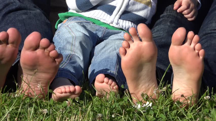 Happy Family Feet Barefoot, Child And Parents Soles In The Grass Stock ...