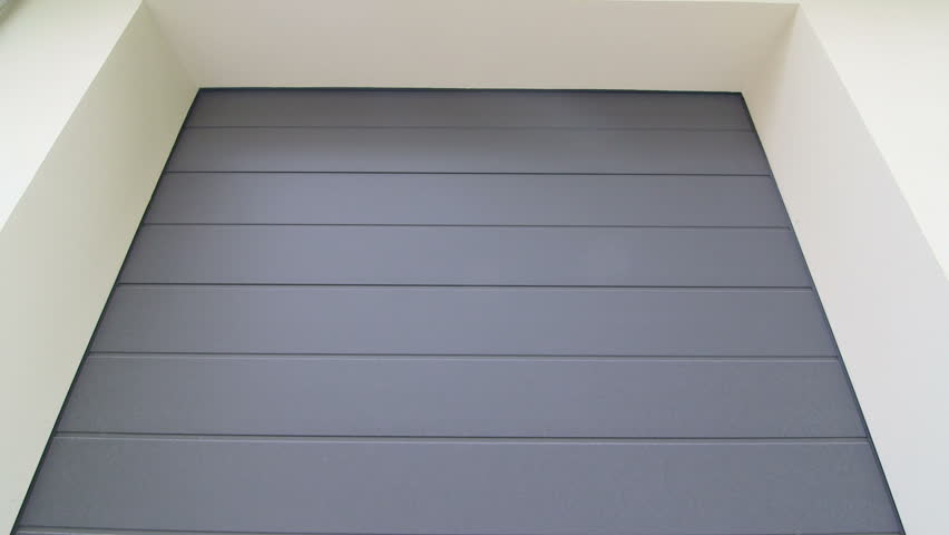 Residential Automatic Garage Door Roll Up On Tracks Across The Ceiling