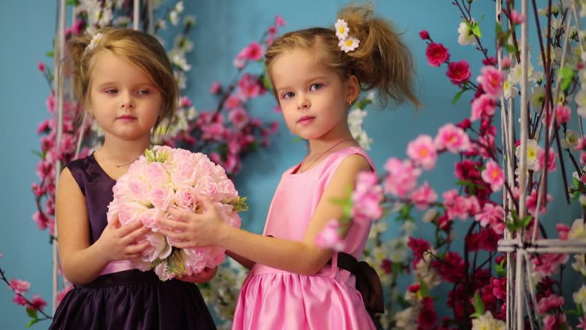 Two Little Girls In Dresses Hold Bouquets Of Roses In Pitchers And ...