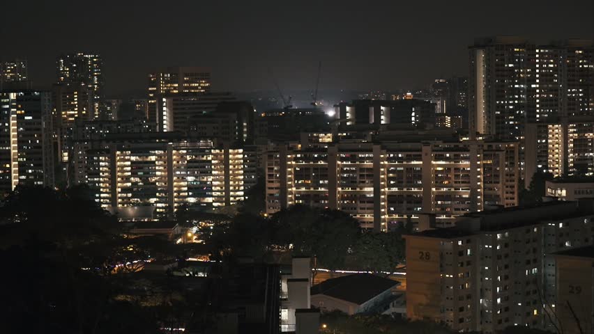 Apartment Building At Night singapore - march 2015 construction cranes on residental apartment Apartment Building At Night singapore - march 2015 construction cranes on residental apartment
