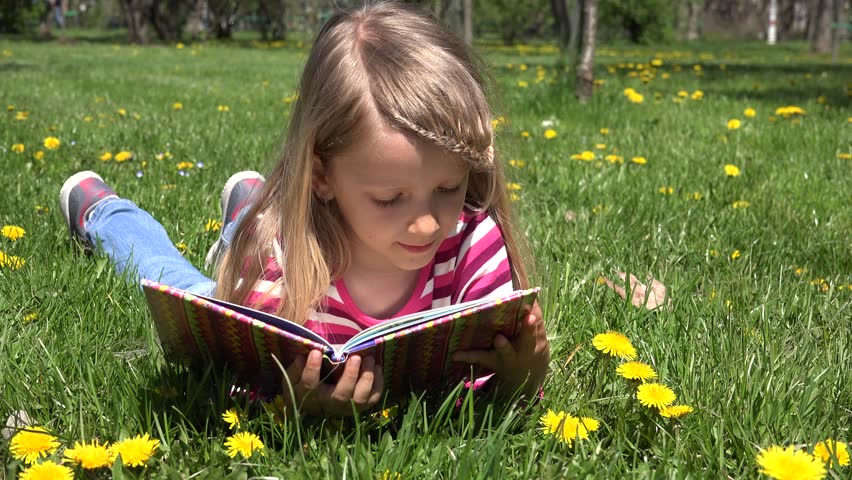 Girl Reading, Lying Down On Grass In The Park Stock Footage Video ...